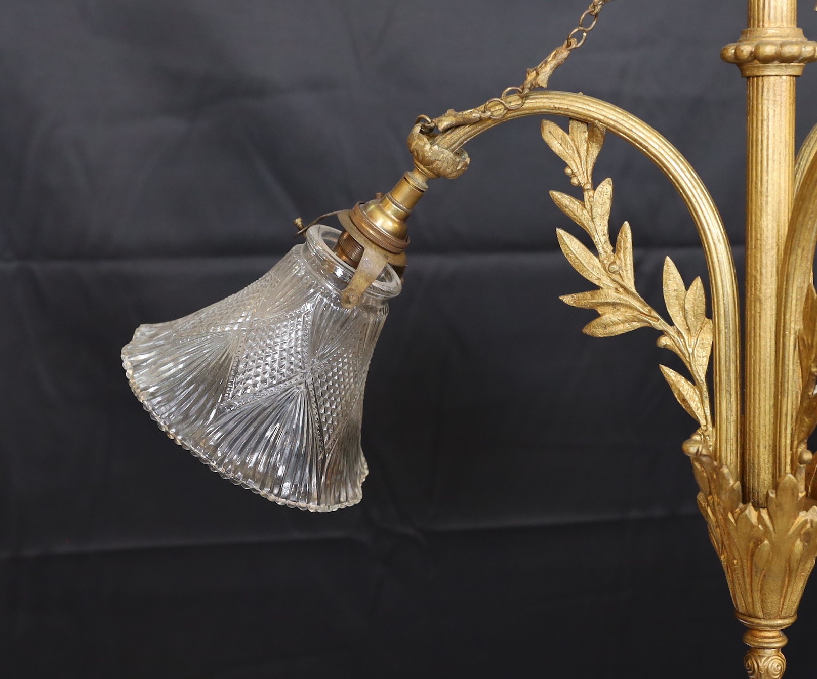 A 20th century French gilt brass three light chandelier with cut glass shades, height 60cm. width 60cm